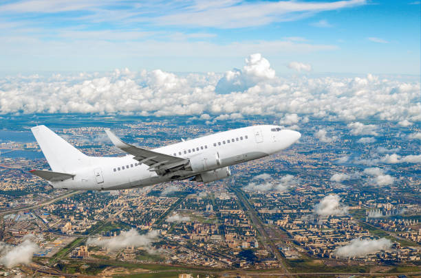 istock Passenger white airplane flies climbing over a large megaopolis, city 850199842