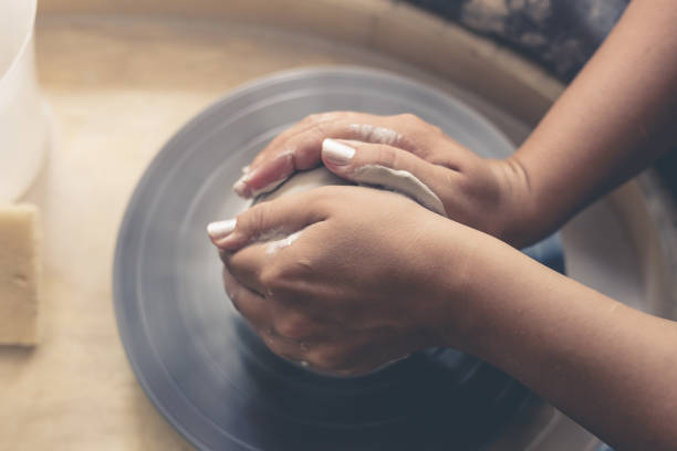 istock Potter works with clay at pottery wheel 850203916