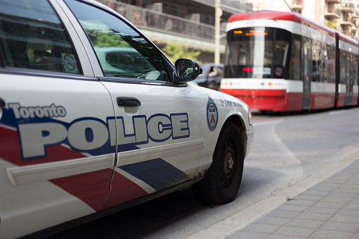 Toronto police car in the street road traffic streetcar public transport transit commuter