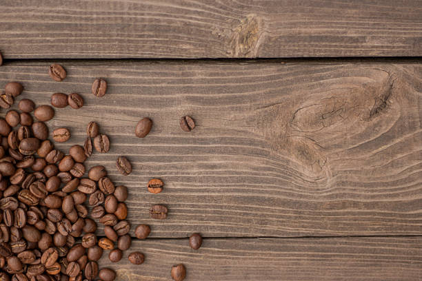 istock Fresh coffee beans on wooden background 850259226