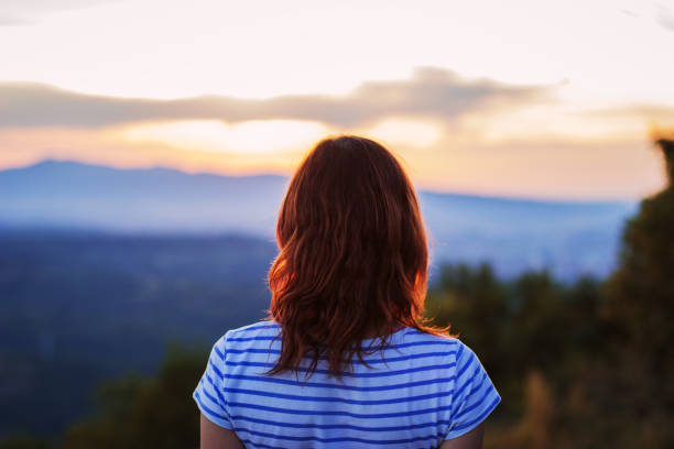 istock Young woman watching sunset 850259434