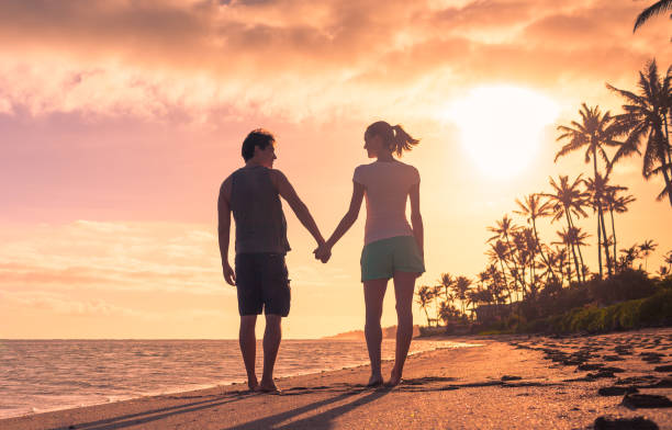 istock Couple walking on the beach 850304282