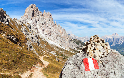 Cima Ambrizzola and Croda da Lago with pathway and tourist sign, Alps Dolomites Mountains, Italy