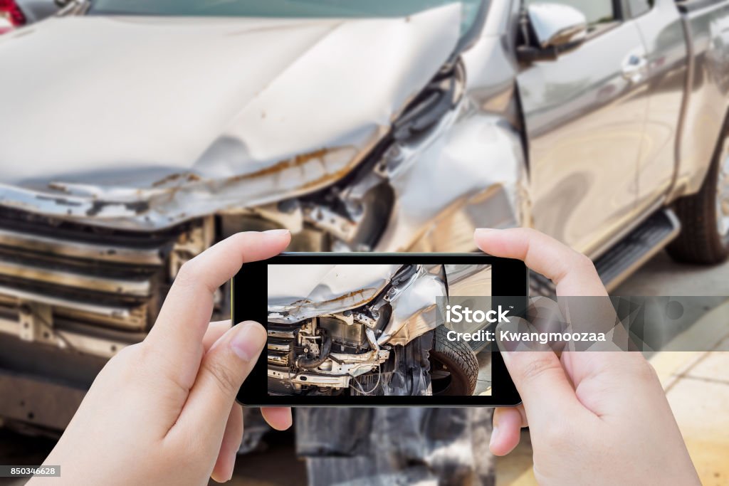 woman using mobile smartphone taking photo of car accident damaged for insurance Car Accident Stock Photo