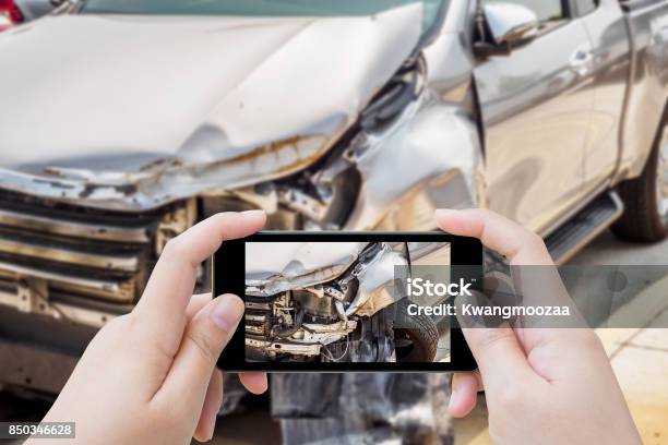 Woman Using Mobile Smartphone Taking Photo Of Car Accident Damaged For Insurance Stock Photo - Download Image Now