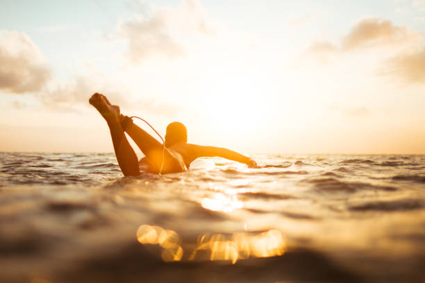 young surfer woman stock photo