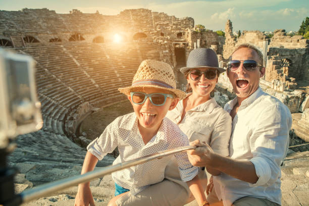 istock Young positive famly take a vacation photo on the Side ampitheatre view 850376860