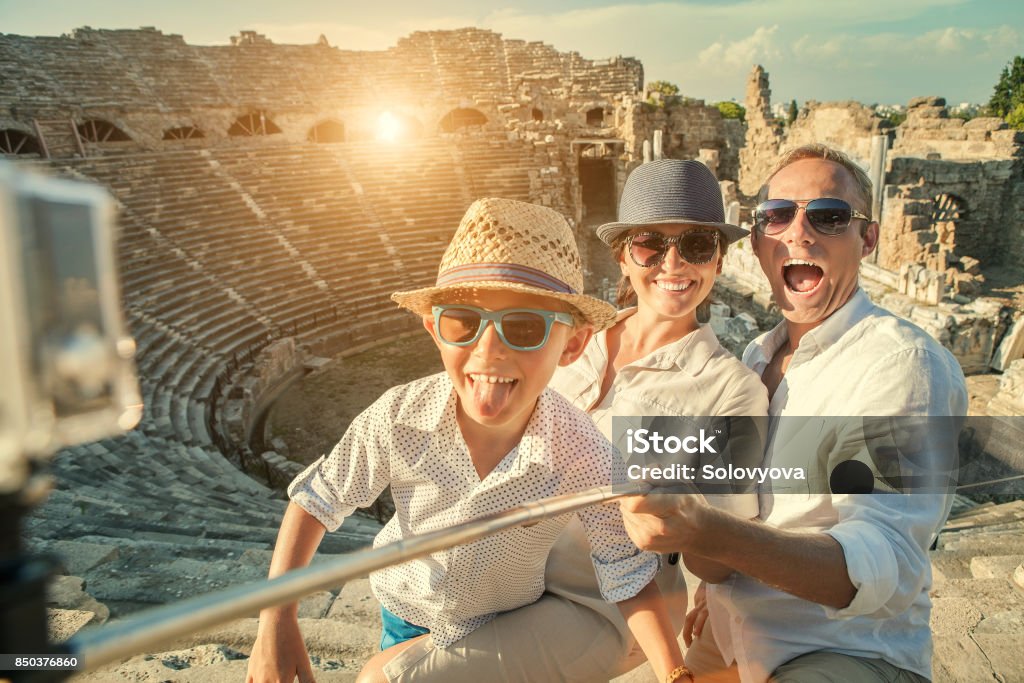 Young positive famly take a vacation photo on the Side ampitheatre view Family Stock Photo