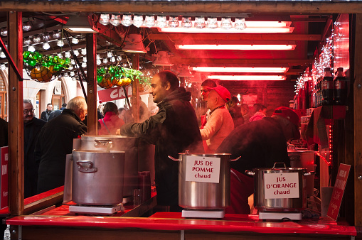 Mulhouse - France - 22 November 2015 - men serving hot drinks at the christmas market