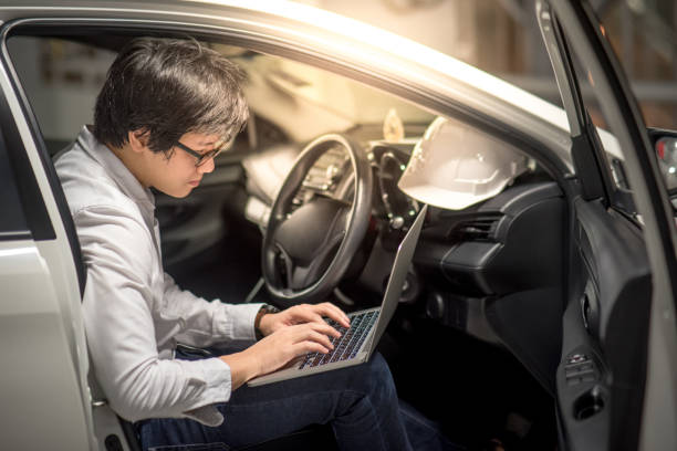 istock Young Asian Engineer or Architect working with laptop computer while sitting in his car 850402490