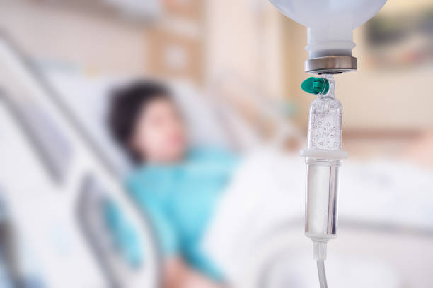 Medical drip with patient in the hospital blurred background Medical drip with patient in the hospital blurred background chemotherapy drug stock pictures, royalty-free photos & images