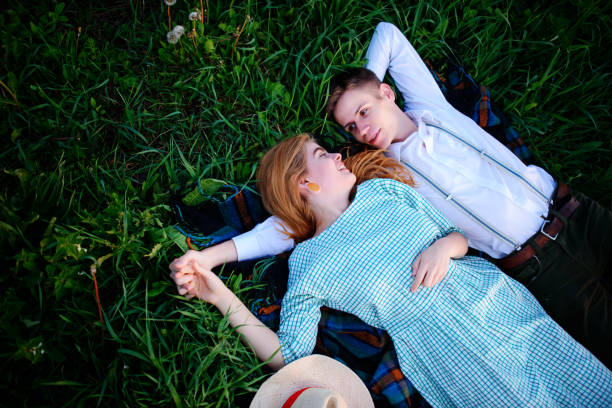 istock young couple lying on the grass and relax, view from above 850426594