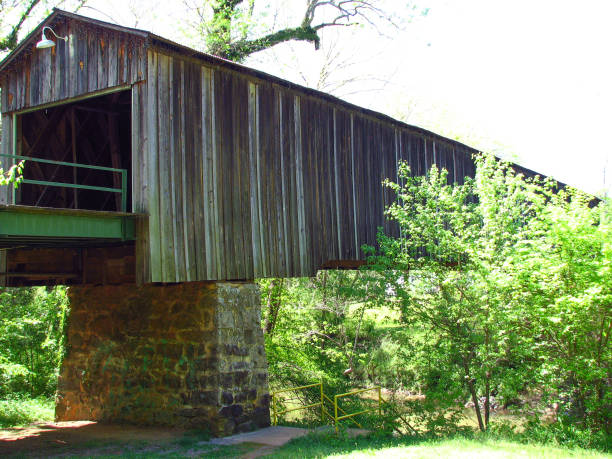 istock Old covered bridge on stone wall supports 850429504