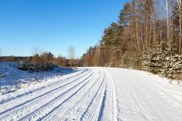 istock rural road covered with snow closeup 850429990