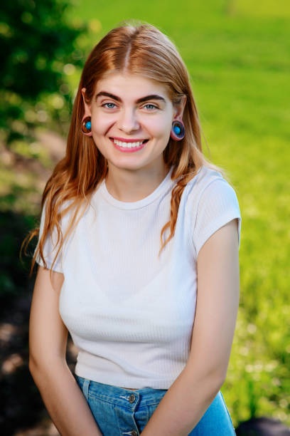 Portrait of a young beautiful woman with wooden tunnels in her ears Portrait of a young beautiful woman with wooden tunnels in her ears. septum piercing stock pictures, royalty-free photos & images