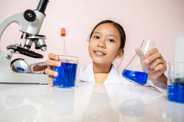 istock Asian girl playing as a scientist to experiment with laboratory equipment and microscope cameras in scientific laboratory. 850450502