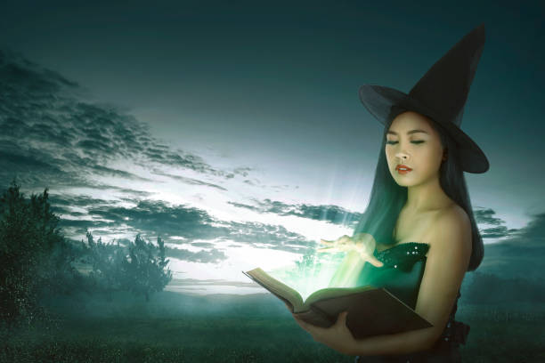 istock Dark asian witch woman with spell book 850451172