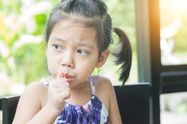 istock Little asian girl feeling happy while eating candy sticks 850506102