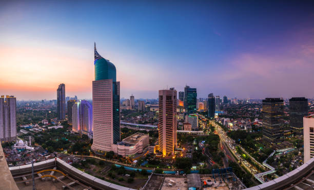 colorfull Jakarta Skyline at dawn colorfull Jakarta Skyline at dawn with the iconic building. The building is one of the most highest building in Indonesia. jakarta stock pictures, royalty-free photos & images