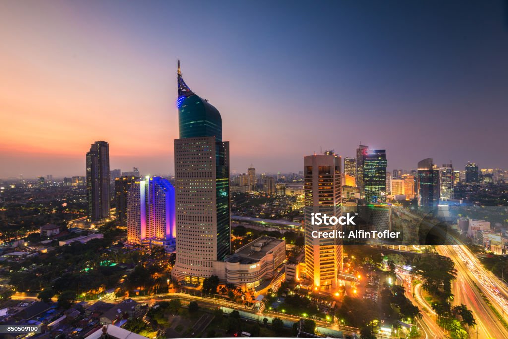 colorfull Jakarta Skyline at dawn colorfull Jakarta Skyline at dawn with the iconic building. The building is one of the most highest building in Indonesia. Wisma Mulia Stock Photo