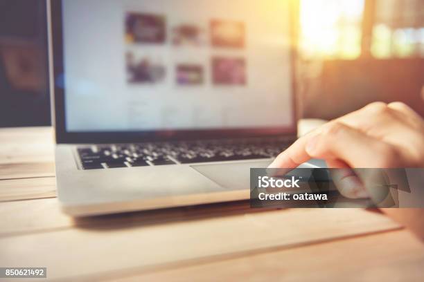 Man Hand Using Touchpad On Laptop At Home Stock Photo - Download Image Now - Choosing, Internet, Adult