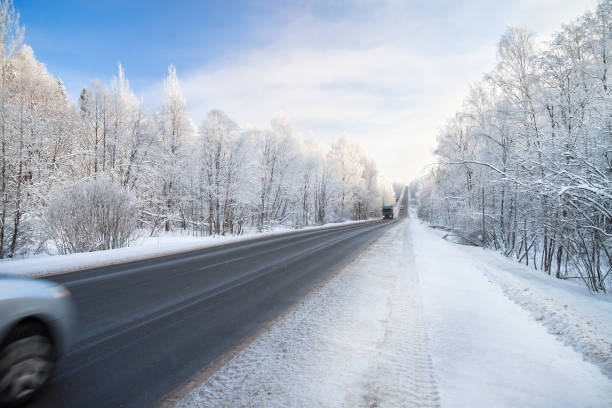 istock winter landscape with asphalt road,forest and blue sky. 850629834
