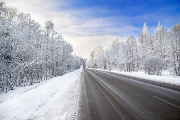 istock winter landscape with asphalt road,forest and blue sky. 850630566