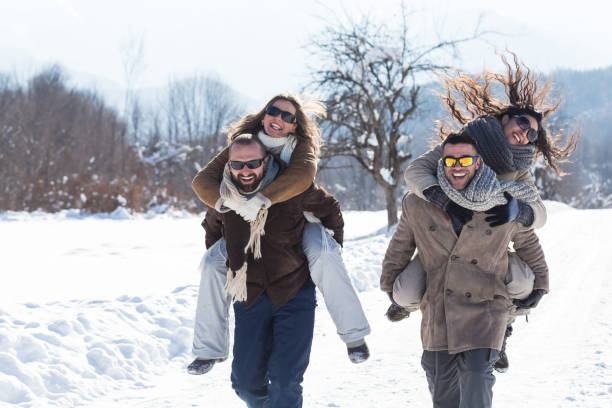 istock Young couples having fun in the snow 850663908