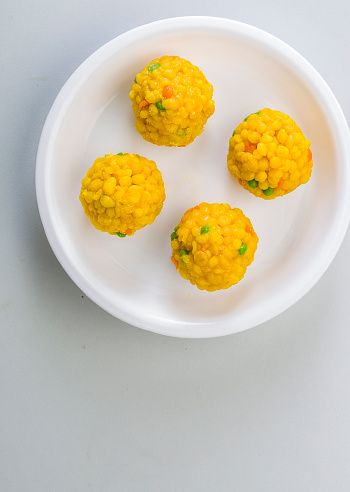Laddu or laddoo are ball-shaped sweets popular in the Indian subcontinent. Laddus are made of flour, minced dough and sugar with other ingredients that vary by recipe. They are often served at festive or religious occasions.