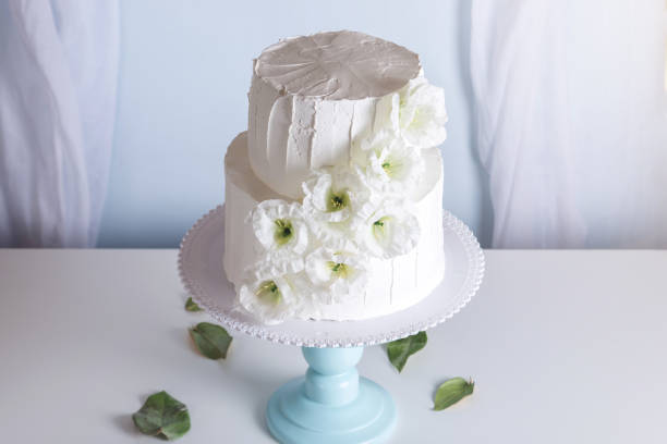 istock White bunk wedding cake decorated with flowers 850680518