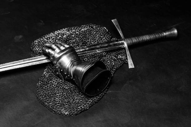 Armor and sword Medieval chain mail, iron gauntlet and a bastard sword still life armored-clothing stock pictures, royalty-free photos & images