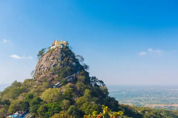 Famous buddhist temple on the summit of Taung Kalat volcano near Mt. Popa. 777 stairs have to be climbed barefoot along with monkeys to reach the top, end of pilgrimage. Myanmar