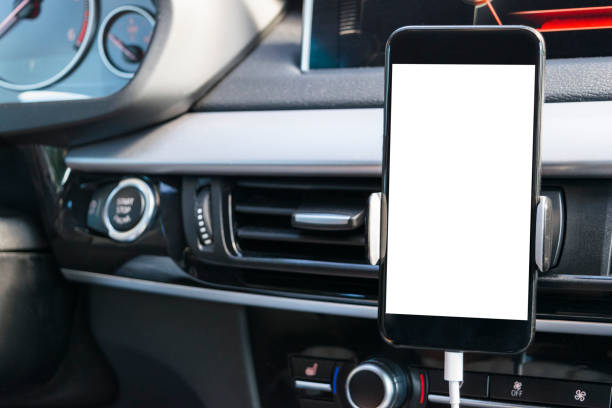 istock Smartphone in a car use for Navigate or GPS. Driving a car with Smartphone in holder. Mobile phone with isolated white screen. Blank empty screen. copy space. Empty space for text. modern car interior details. 850688016