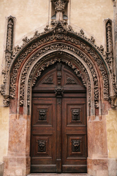 belle porte ancienne à côté de l’horloge astronomique sur la place principale de prague en république tchèque. - prague old door house photos et images de collection