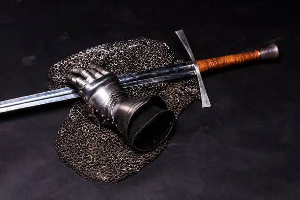 Medieval chain mail, iron gauntlet and a bastard sword still life