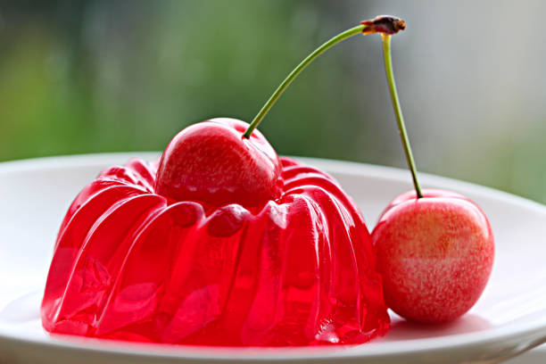 istock cherry jelly with berry cherry on a blurred green background 850692484