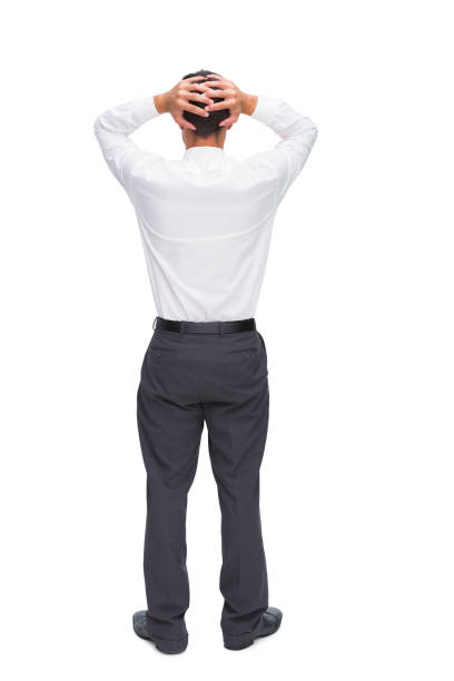 istock Businessman standing back to camera hands on head 850695830