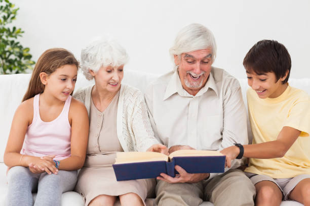istock Grandparents reading book with grandchlidren 850695868