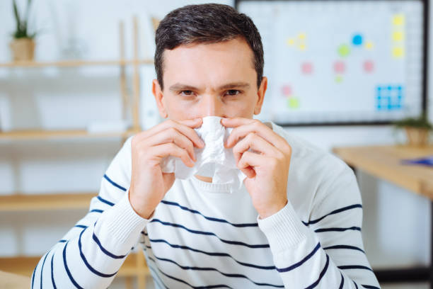 istock Angry brunette man blowing nose 850695954