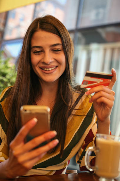 istock Young woman using smart phone and credit card. 850705958