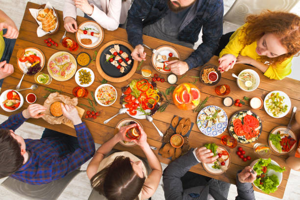 istock People eat healthy meals at served table dinner party 850710122