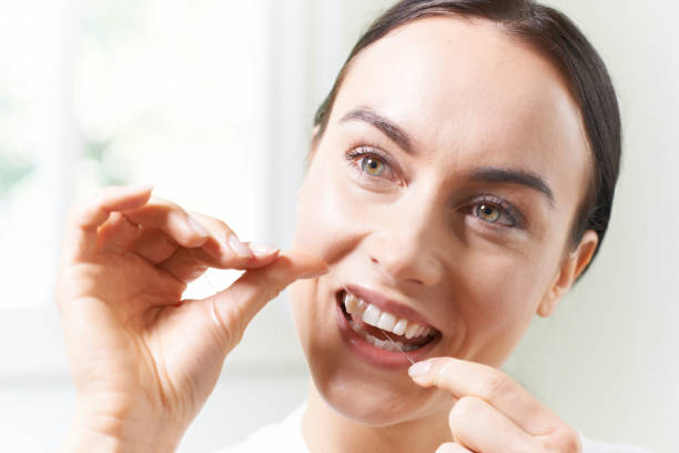istock Young Woman Flossing Teeth In Bathroom 850712888
