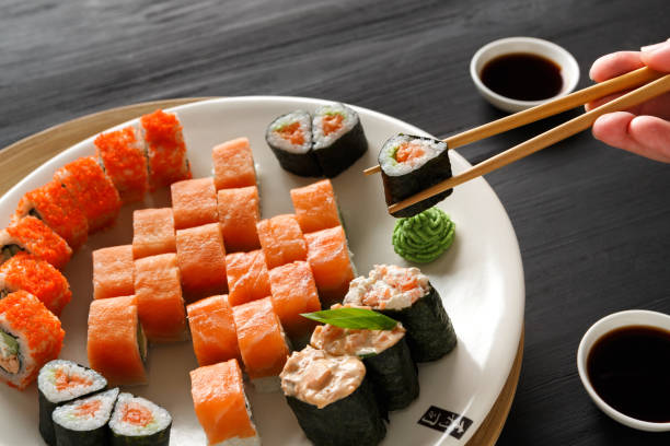 istock Eating sushi and rolls in japanese restaurant 850713302
