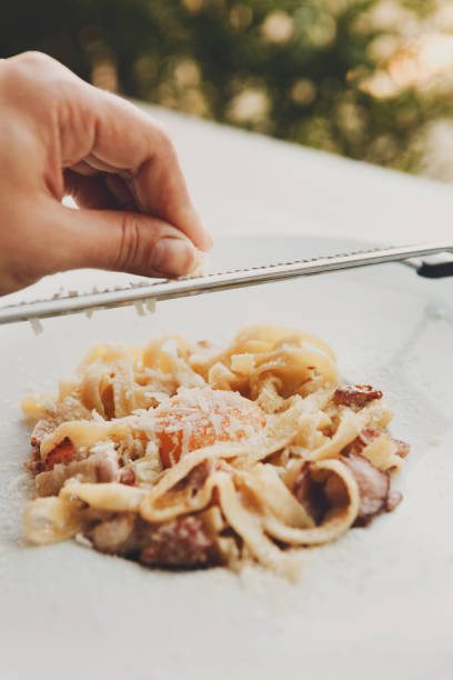 istock Grate parmesan on traditional italian pasta carbonara with bacon and egg 850730578