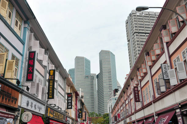 Singapore, Singapore -Sep 16, 2017: Rows of shophouses along Liang Seah Street in the foreground and SUNTEC City in the distance.
