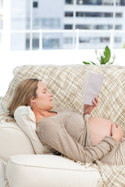 istock Portrait of a future mom reading a book lying 850759490