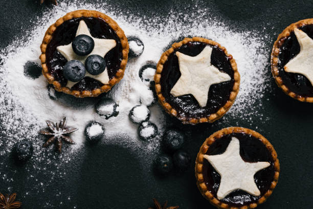 istock Tarts filled with jam, whole blueberries and sugar powder, top view 850763716