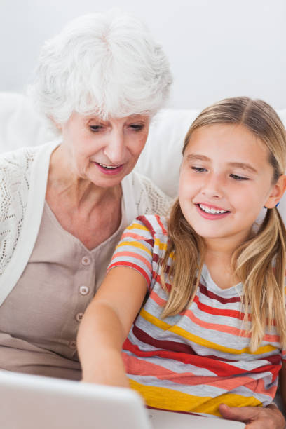 istock Little girl and granny using laptop 850763750