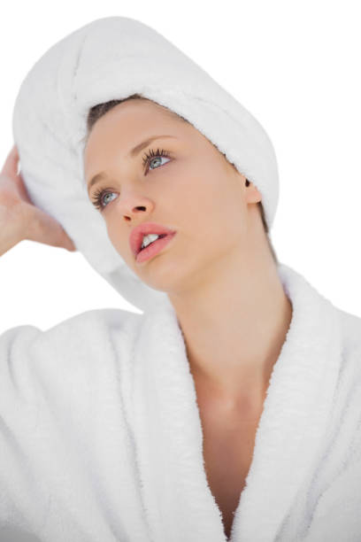 istock Contemplative brunette in bathrobe looking away 850764552