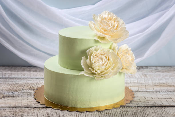 istock Beautiful home made wedding two-tiered cake decorated with beige roses. 850768496